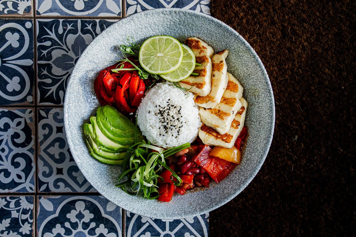 Grilled halloumi rice bowl with avocado, peppers and lime