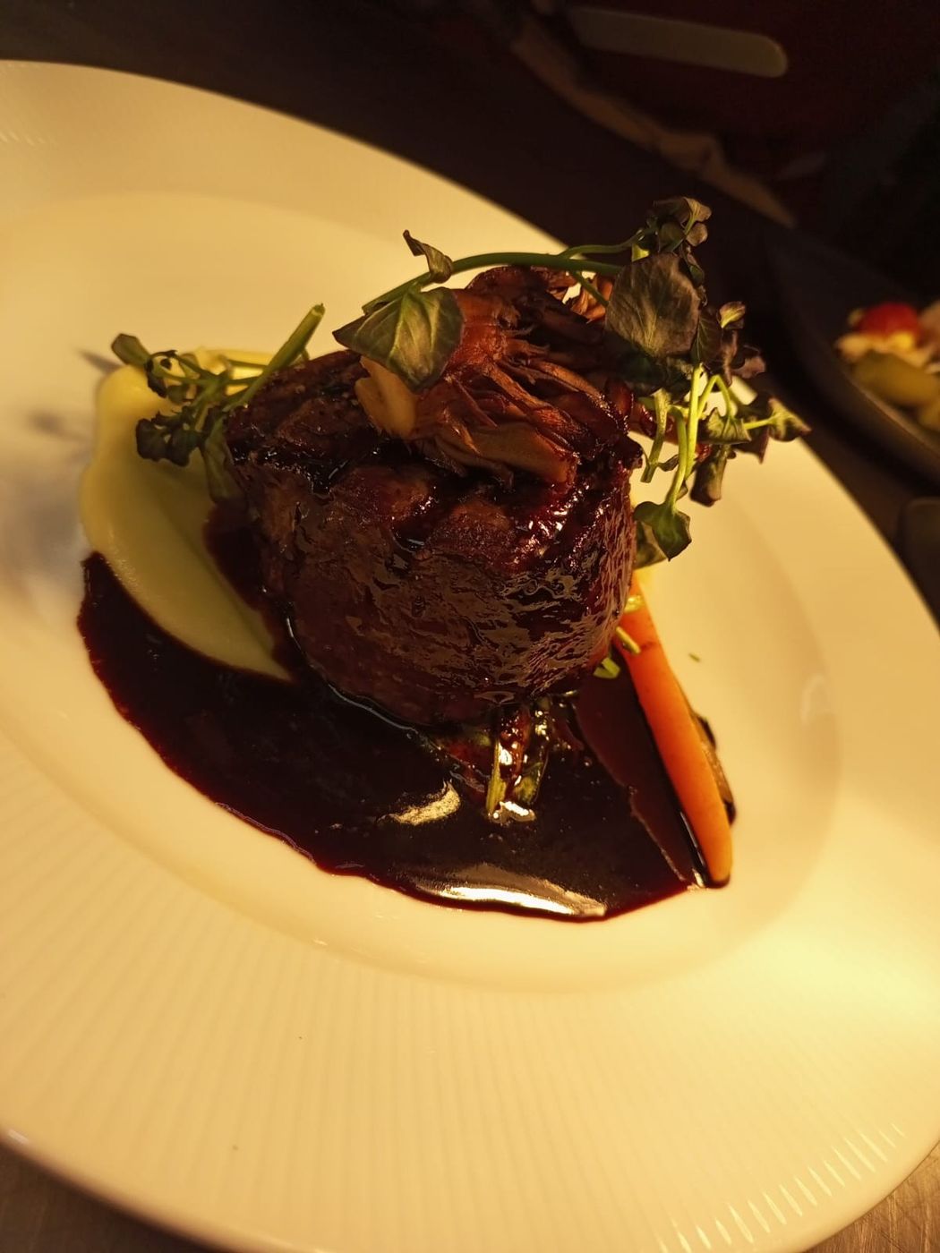 Fillet of beef finished with a red wine reduction, plated by a Concord student